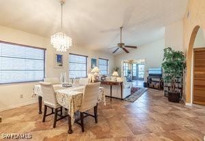 595 103rd Ave, Naples, FL 34108 - dining area with plenty of natural light, ceiling fan with notable chandelier, and lofted ceiling
