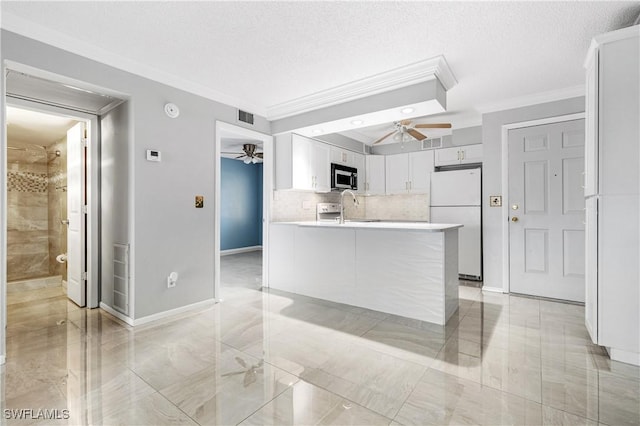 kitchen with sink, white cabinets, white refrigerator, ceiling fan, and crown molding