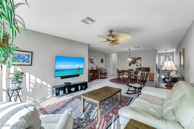 living room with ceiling fan, carpet floors, and visible vents