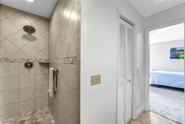 ensuite bathroom with a closet, tiled shower, connected bathroom, and tile patterned floors