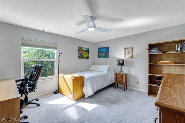 bedroom with light carpet, baseboards, and a ceiling fan