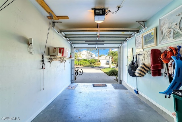 garage with baseboards and a garage door opener