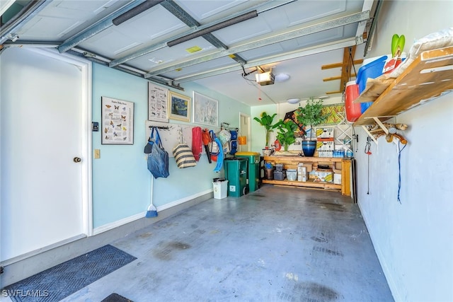 garage with a garage door opener and baseboards