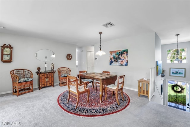 dining room featuring baseboards, visible vents, and carpet flooring