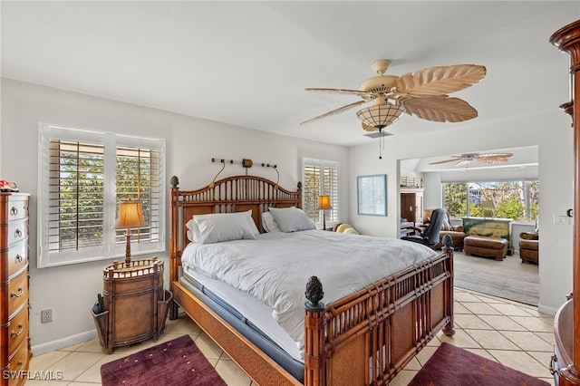 bedroom featuring ceiling fan, light tile patterned flooring, and baseboards