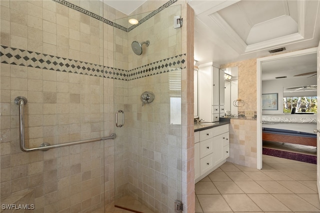 bathroom featuring a raised ceiling, connected bathroom, ornamental molding, vanity, and a shower stall