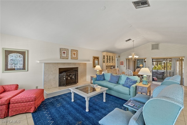 living area featuring lofted ceiling, visible vents, a notable chandelier, and light tile patterned flooring