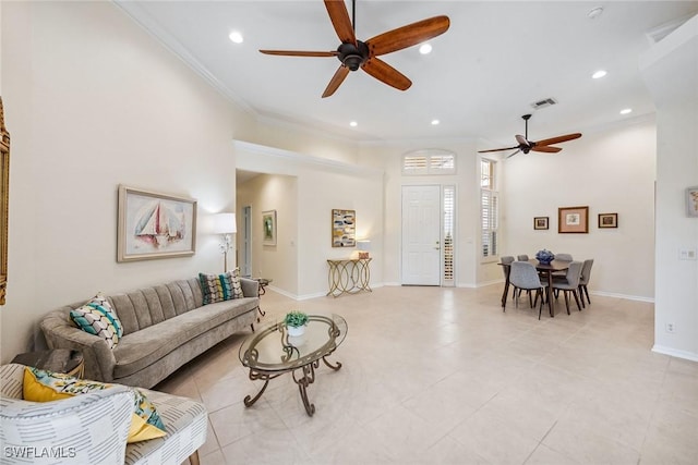 living room featuring light tile patterned floors, ornamental molding, and ceiling fan