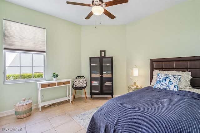 tiled bedroom with ceiling fan