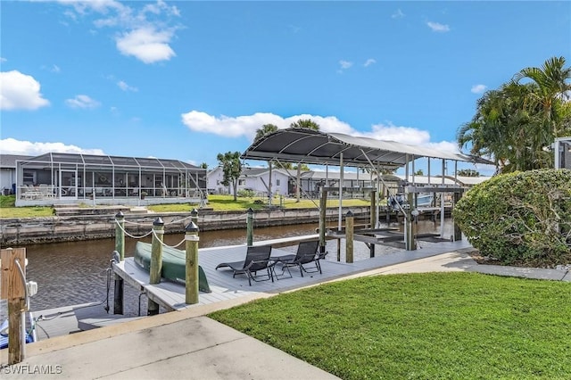 dock area with a lawn and a water view