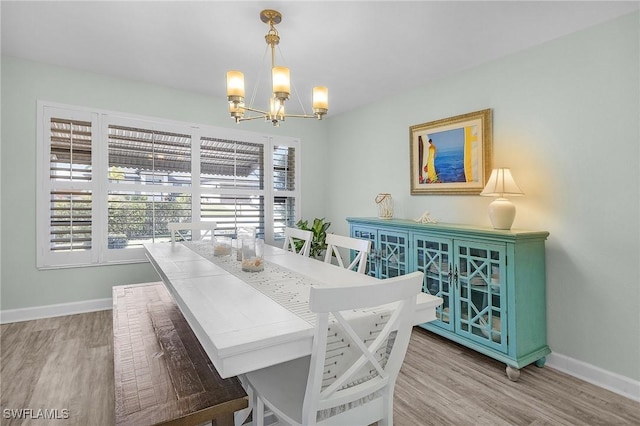 dining room featuring wood-type flooring and a chandelier