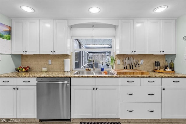 kitchen with stainless steel dishwasher, sink, and white cabinets