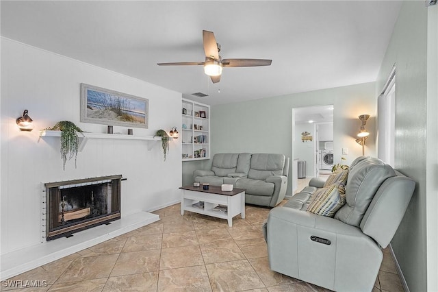 living room with ceiling fan and washer / clothes dryer