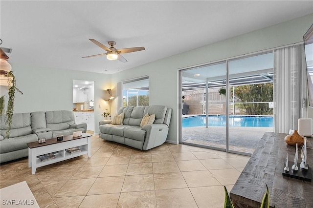 tiled living room featuring ceiling fan