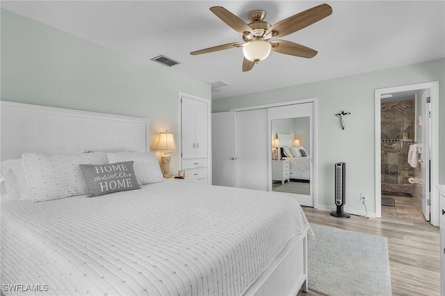 bedroom featuring ceiling fan, ensuite bathroom, and light wood-type flooring