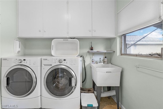 laundry room with separate washer and dryer, sink, and cabinets