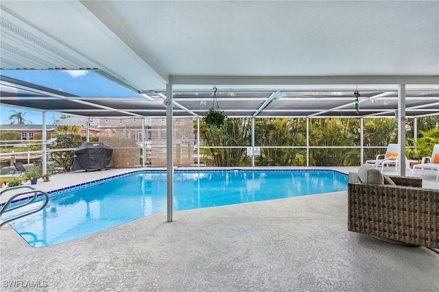 view of swimming pool with area for grilling, a lanai, and a patio area