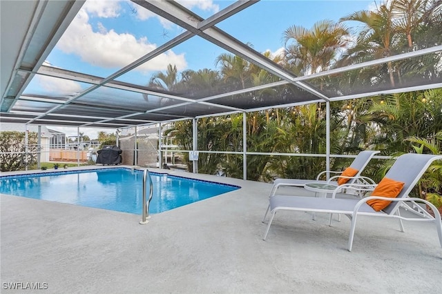 view of pool featuring a patio area and glass enclosure