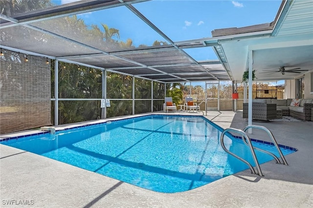 view of pool with a lanai, an outdoor hangout area, ceiling fan, and a patio area