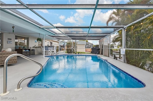 view of swimming pool with area for grilling, a patio area, and glass enclosure