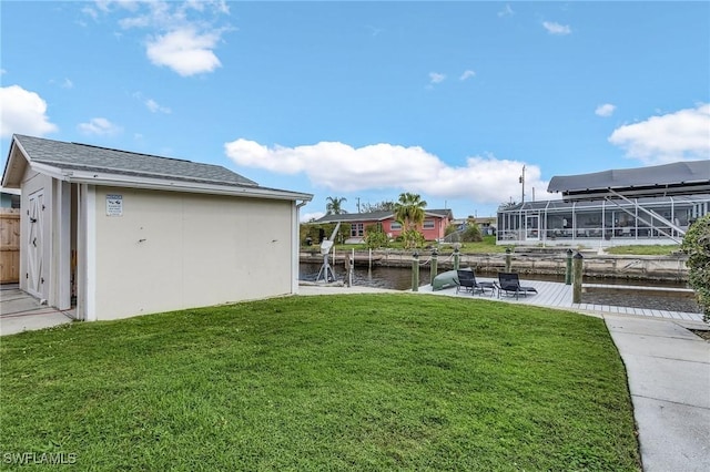 view of yard featuring a water view and a dock