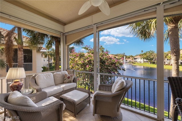 sunroom featuring a water view and ceiling fan