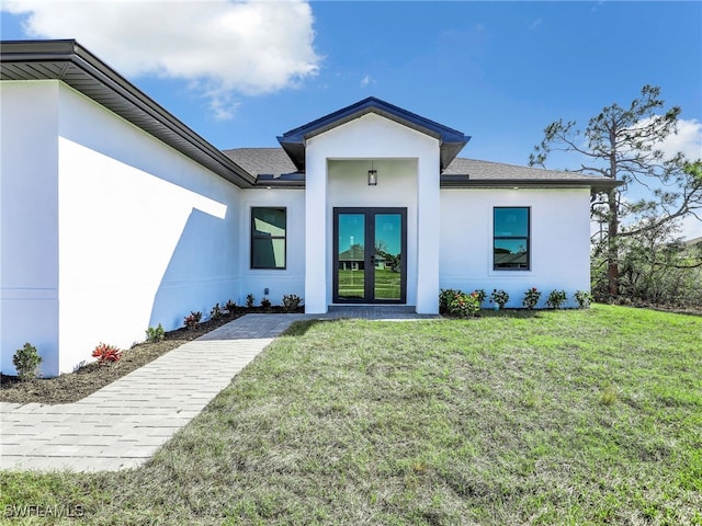 1302 NW 13th Ter, Cape Coral, FL 33993 - doorway to property with stucco siding, a lawn, french doors, and a shingled roof