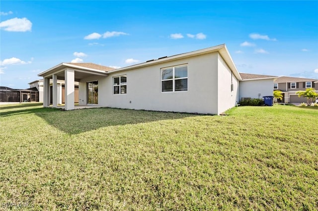 rear view of property with a patio area and a yard