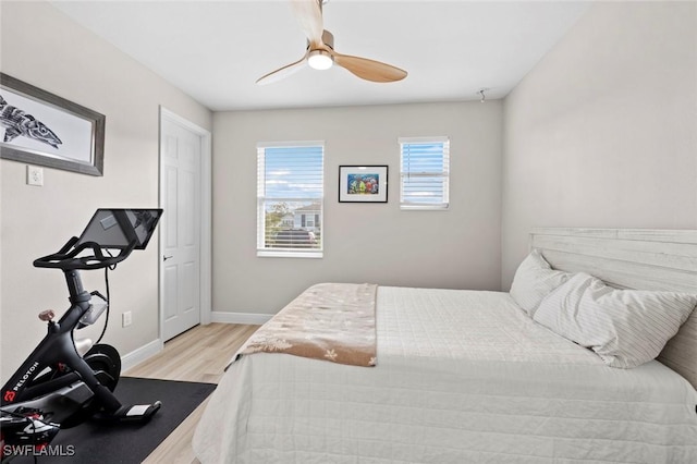 bedroom with light hardwood / wood-style floors and ceiling fan