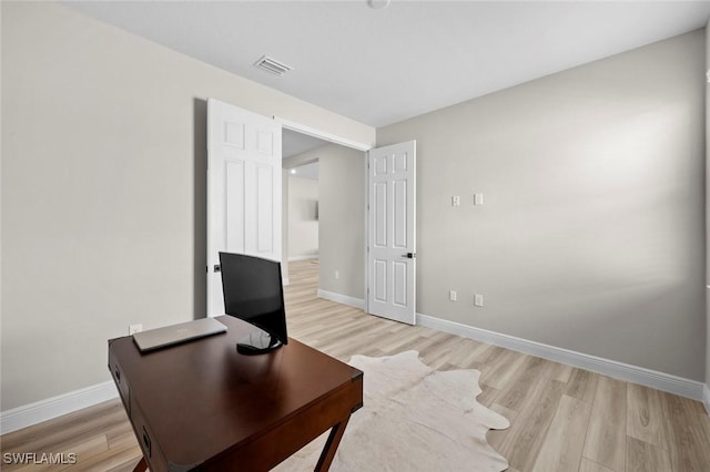 office space with light hardwood / wood-style flooring