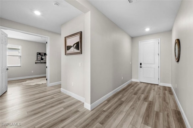 corridor with light wood-type flooring