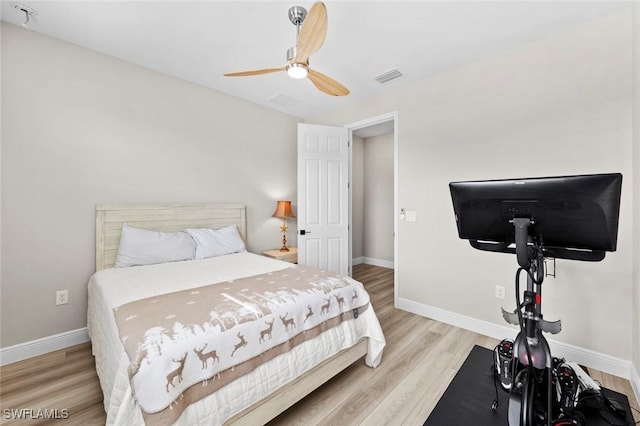 bedroom with ceiling fan and light hardwood / wood-style floors