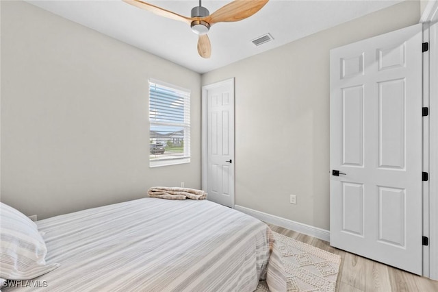 bedroom with light hardwood / wood-style floors and ceiling fan