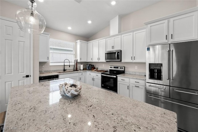 kitchen with appliances with stainless steel finishes, sink, decorative light fixtures, white cabinets, and light stone countertops