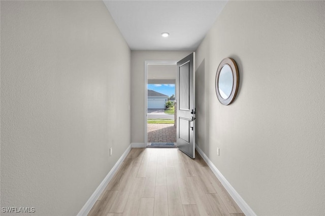 doorway to outside with light wood-type flooring