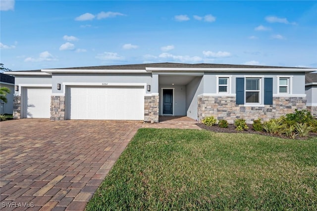 view of front of house with a garage and a front yard