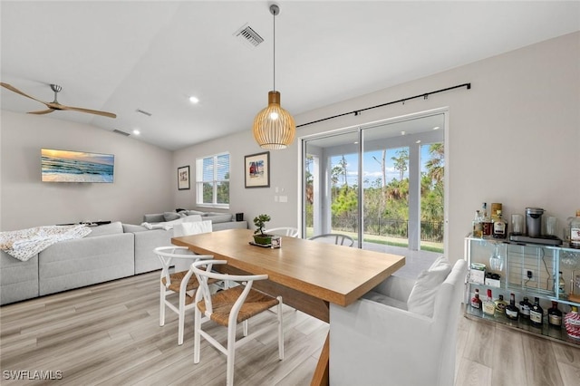 dining space with light hardwood / wood-style floors, lofted ceiling, and ceiling fan