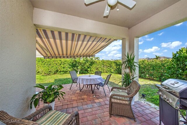 view of patio / terrace featuring grilling area, outdoor dining area, and a ceiling fan