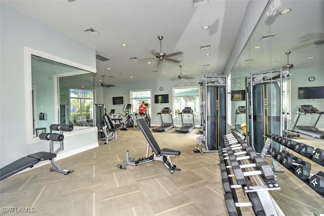 workout area featuring light carpet, plenty of natural light, and visible vents