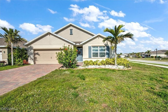 ranch-style home with decorative driveway, an attached garage, a front lawn, and stucco siding