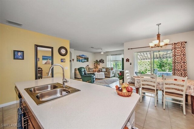 2733 Merida Ln, Cape Coral, FL 33909 - kitchen with light countertops, light tile patterned floors, visible vents, and a sink