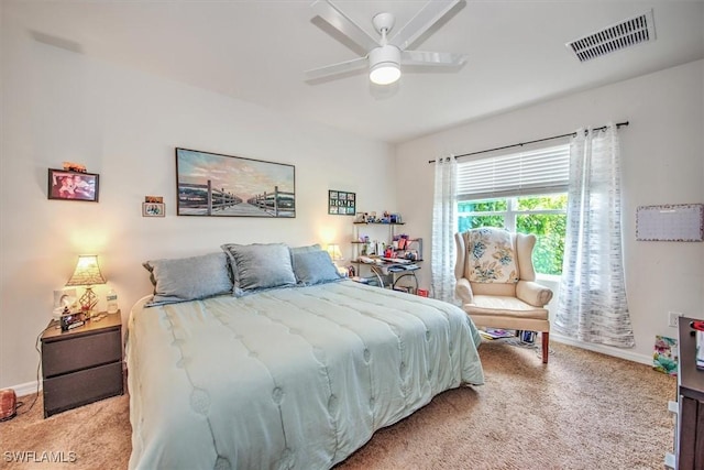 bedroom featuring baseboards, ceiling fan, visible vents, and light colored carpet