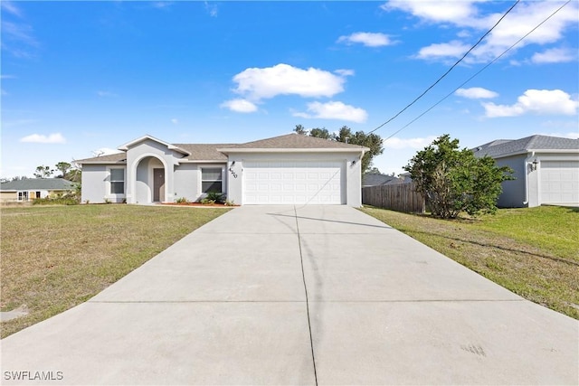 view of front facade featuring stucco siding, an attached garage, fence, driveway, and a front lawn