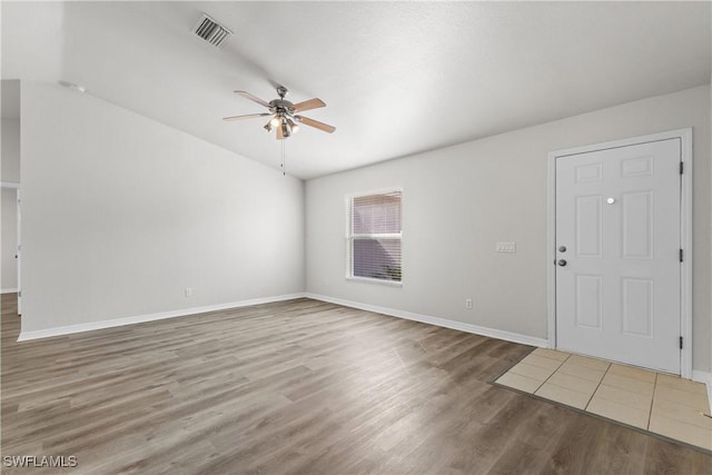 interior space with visible vents, ceiling fan, baseboards, and wood finished floors