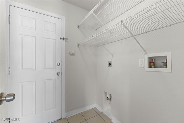 laundry room with laundry area, baseboards, washer hookup, electric dryer hookup, and light tile patterned flooring