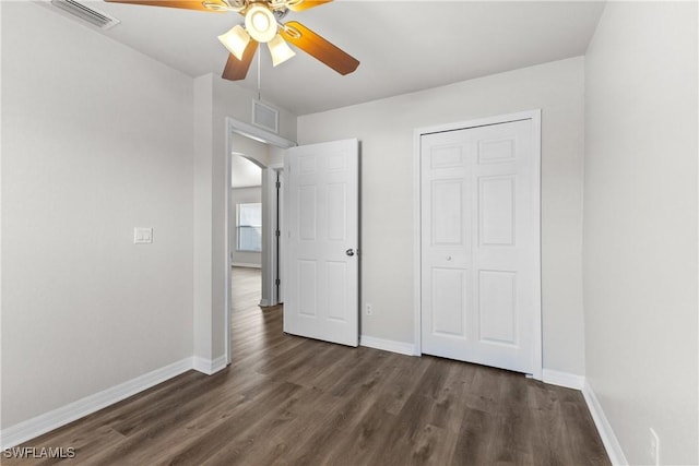 unfurnished bedroom with wood finished floors, visible vents, and baseboards