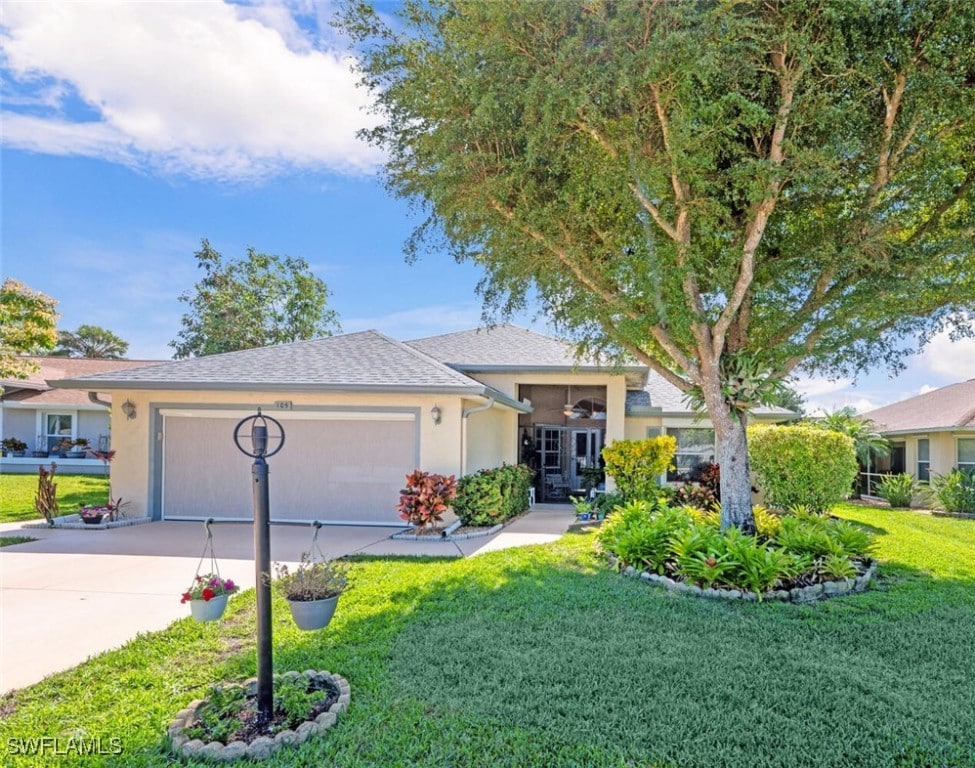 ranch-style house with a garage and a front lawn