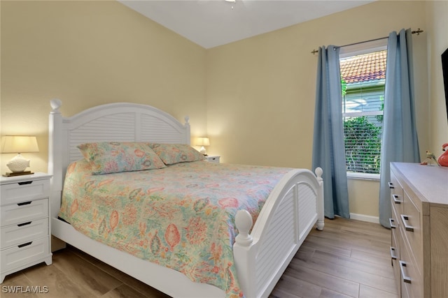 bedroom featuring light wood-style floors and baseboards