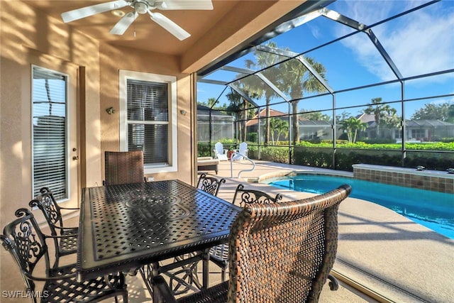 view of patio with a lanai, a ceiling fan, and an outdoor pool