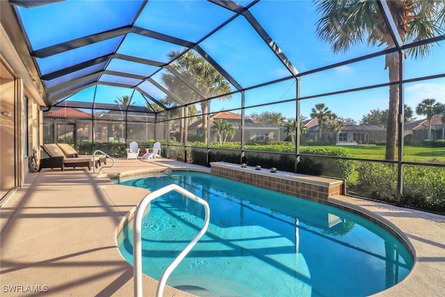 pool with glass enclosure, a patio area, and a residential view